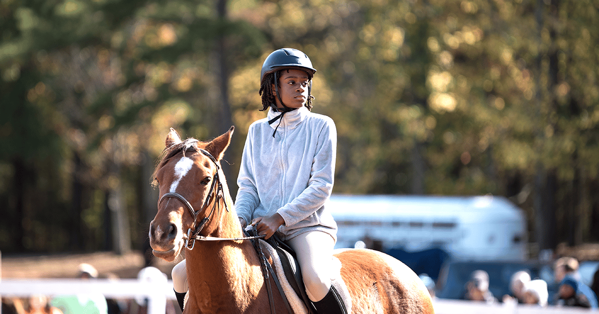 alt=Photo of young child participating in the Horse Show at Anne Springs Close Greenway