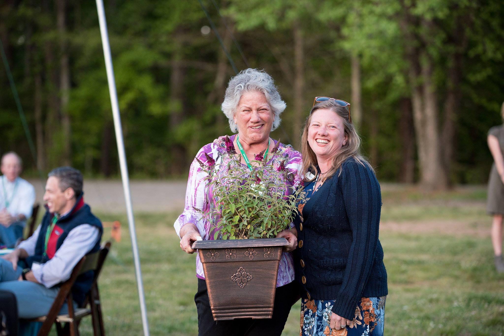 alt=Photo of Plant a Row Lead Volunteer, Betsy McLean, smiling at the camera with her with her daughter