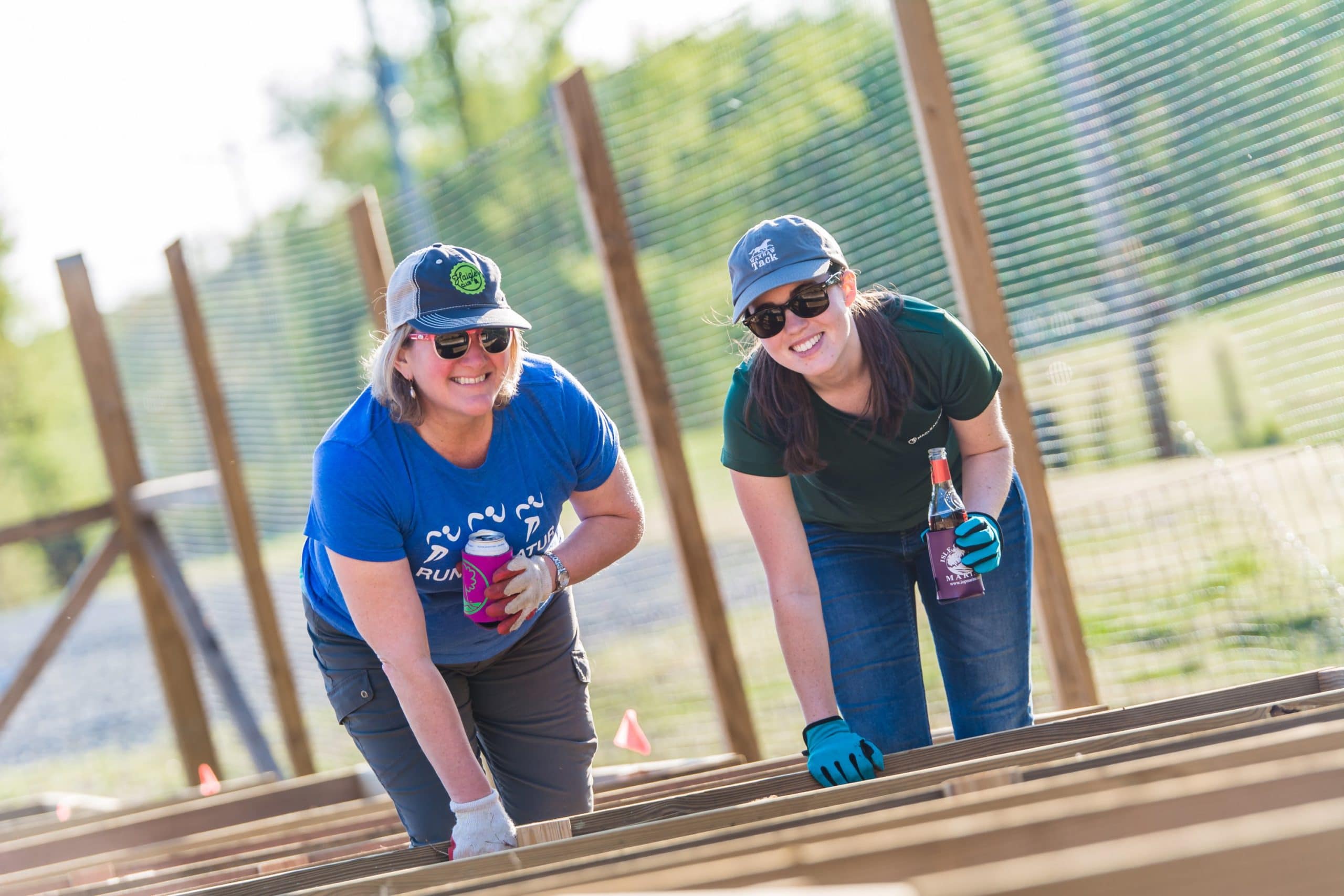 Photo of 2 female volunteers working in the Plant-a-Row Garden at the Anne Springs Close Greenway