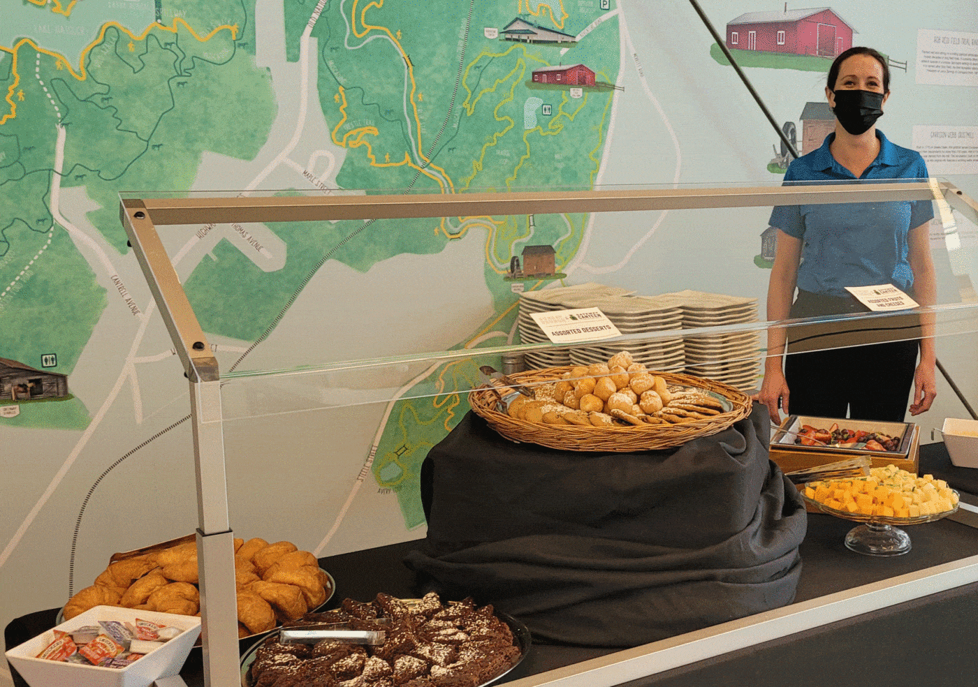Photo of server posing next to food at the Gateway Canteen Brunch