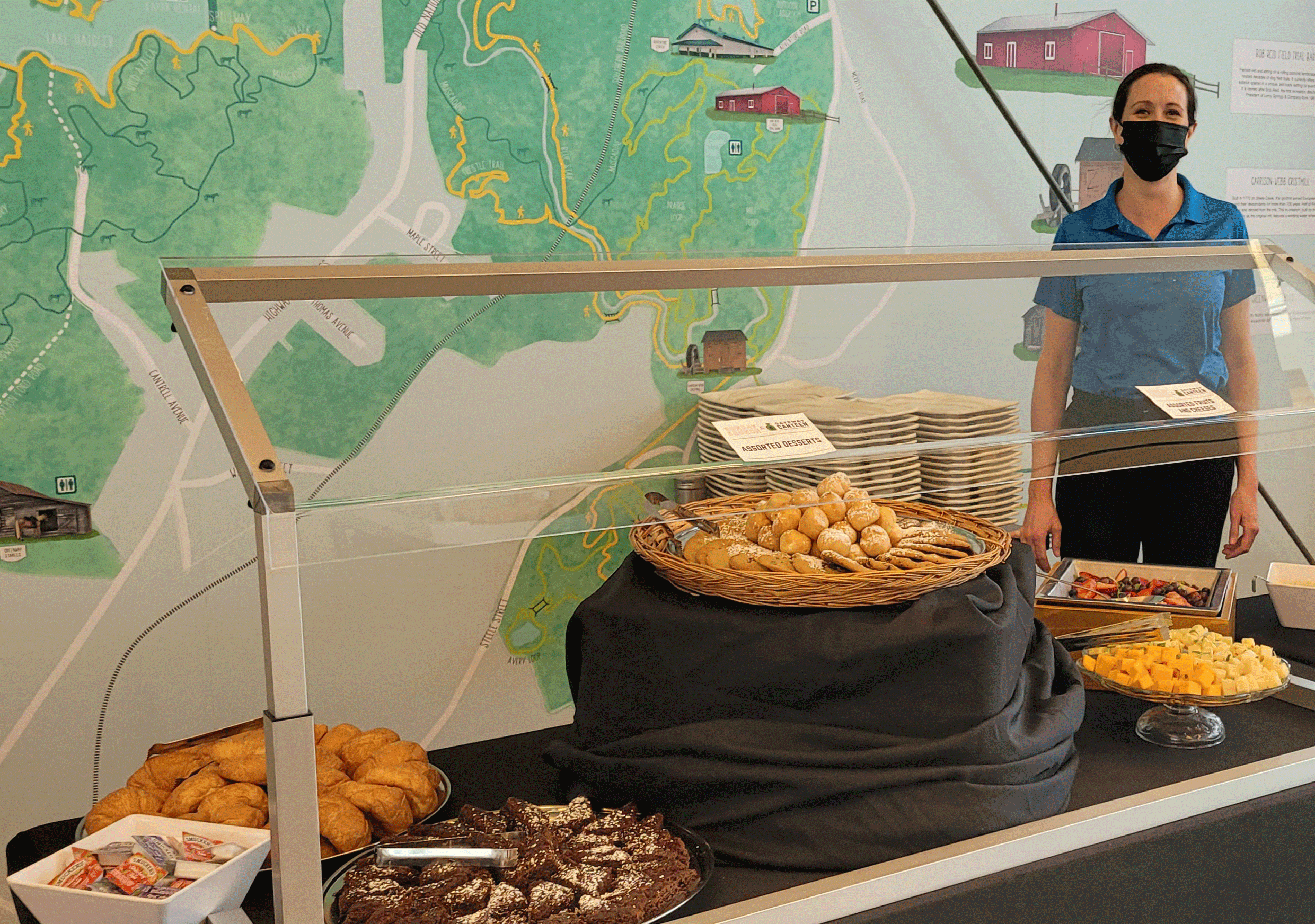 Photo of server posing next to food at the Gateway Canteen Brunch