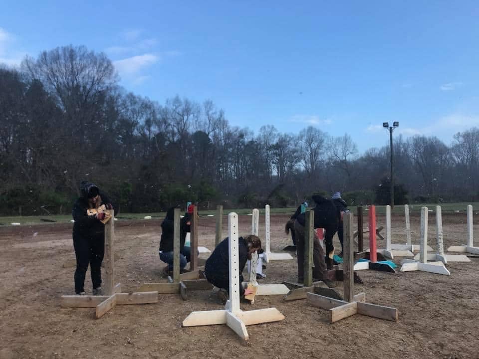 alt=Photo of volunteers assembling equipment at the Greenway Stables at the at the Anne Springs Close Greenway