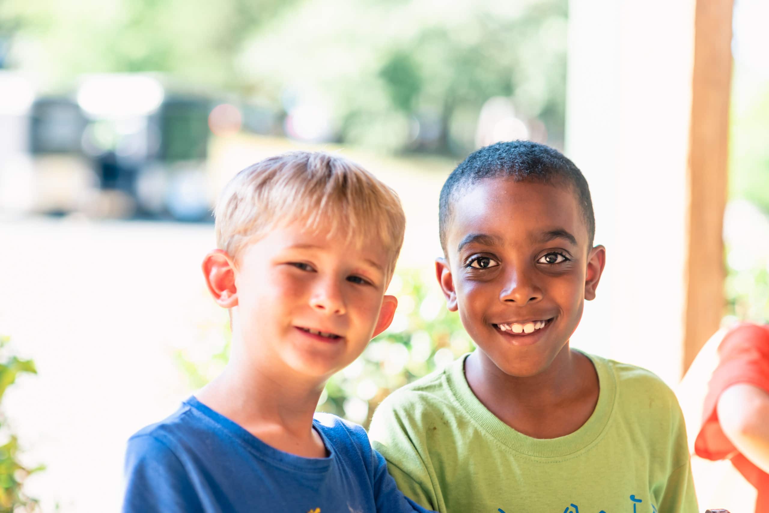 alt=Photo of 2 young boys smiling at the camera at the Anne Springs Close Greenway