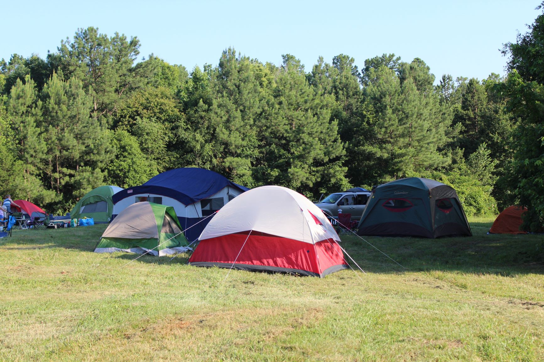 Photo of camping tents propped up on-site of the Anne Springs Close Greenway
