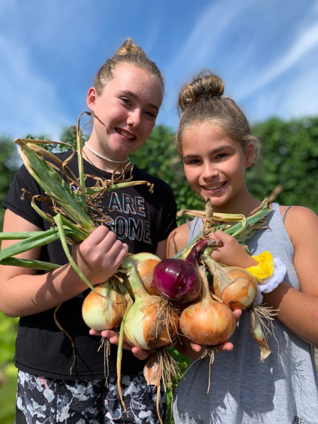 Girlsgardening Photo of 2 girls holding vegetables harvested from the Community Garden at the Anne Springs Close Greenway
