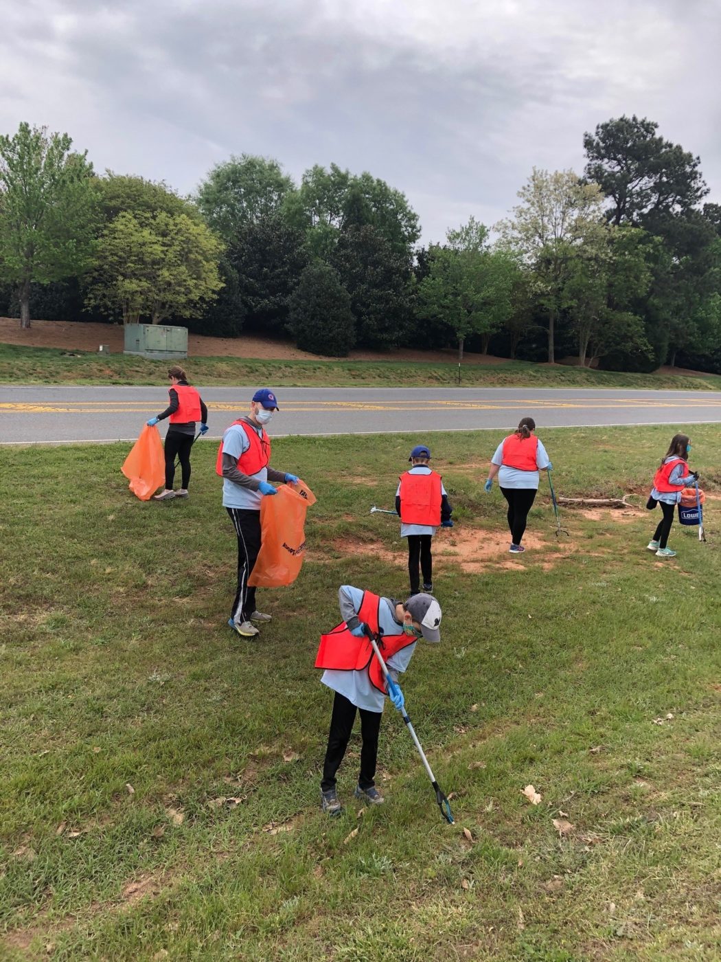 Photo of volunteers picking up trash at the Earth Day Conservation at Anne Springs Close Greenway