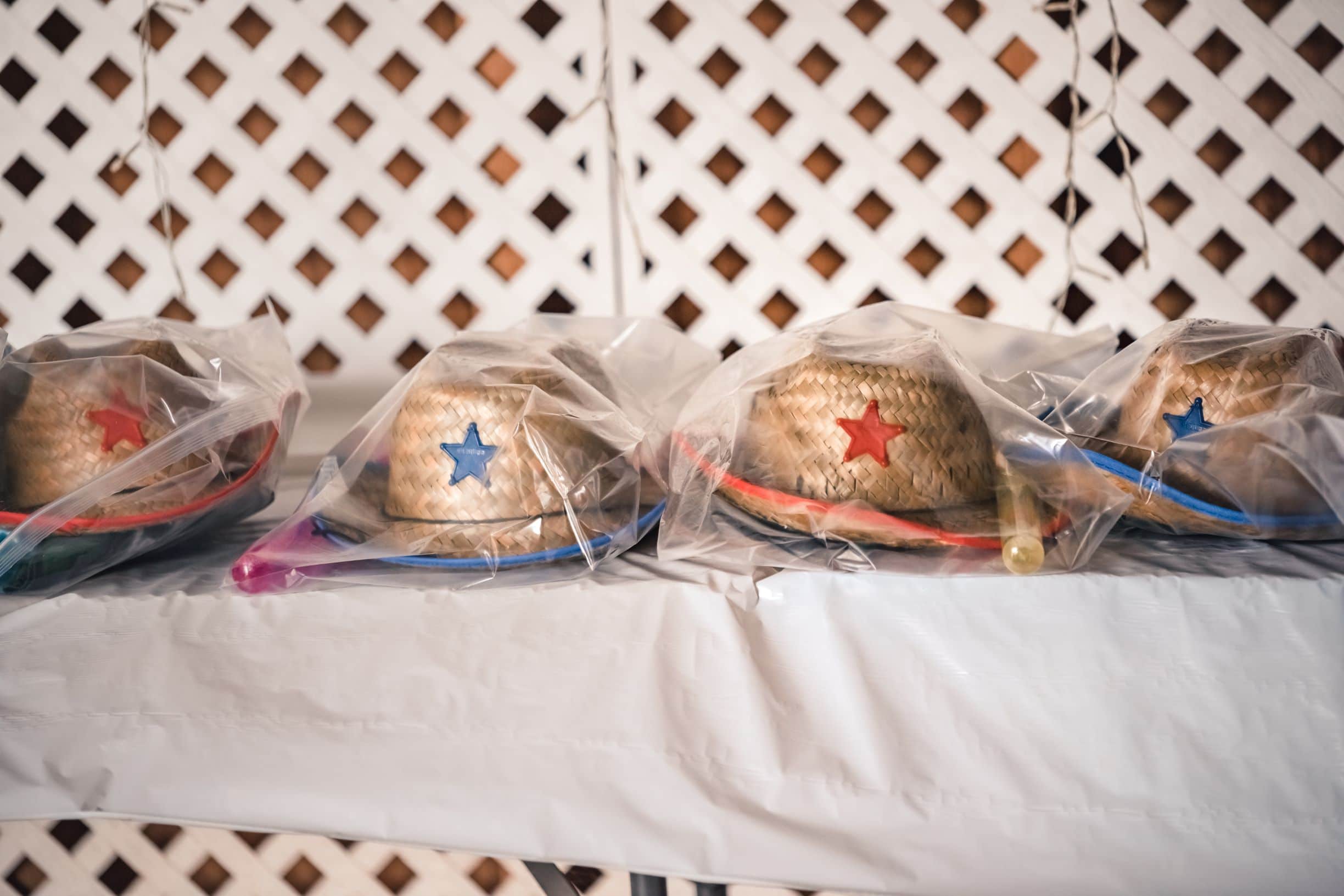 Photo of 4 straw hats sitting on a table