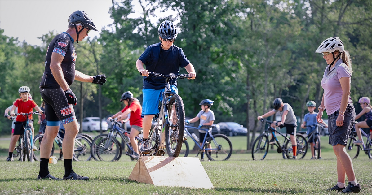 Photo of teen boy learning how to mountain bike at the Anne Springs Close Greenway's Youth Mountain Bike Camp