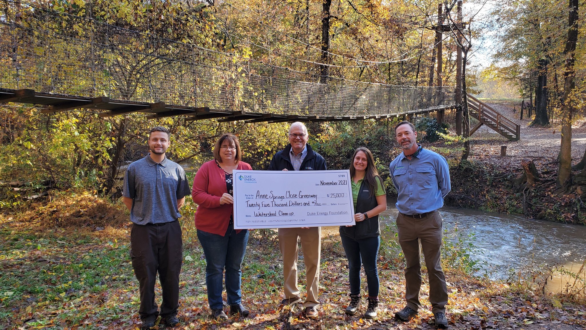 Photo of Anne Springs Close Greenway staff posing with Duke Energy Foundation's grant for a Litter Gitter