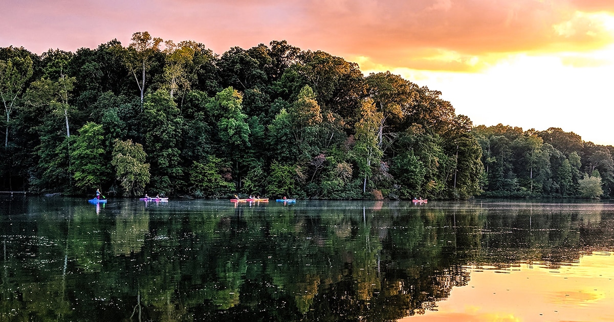 Kayaks on Lake Haigler while the sun sets.