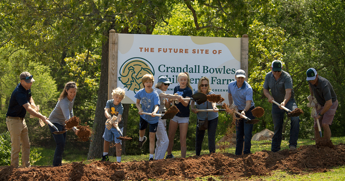 Children and Anne Springs Close Greenway employees shoveling dirt at the Groundbreaking Ceremony of the Crandall Bowles Children's Farm