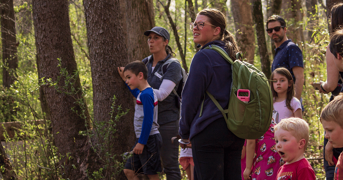 2 Anne Springs Close Greenway tour guides taking children on the History Hike: Pioneers on the Greenway