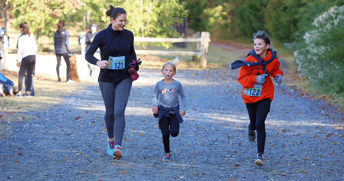 Mother and her 2 daughters running at the Anne Springs Close Greenway's Springmaid Trail Race