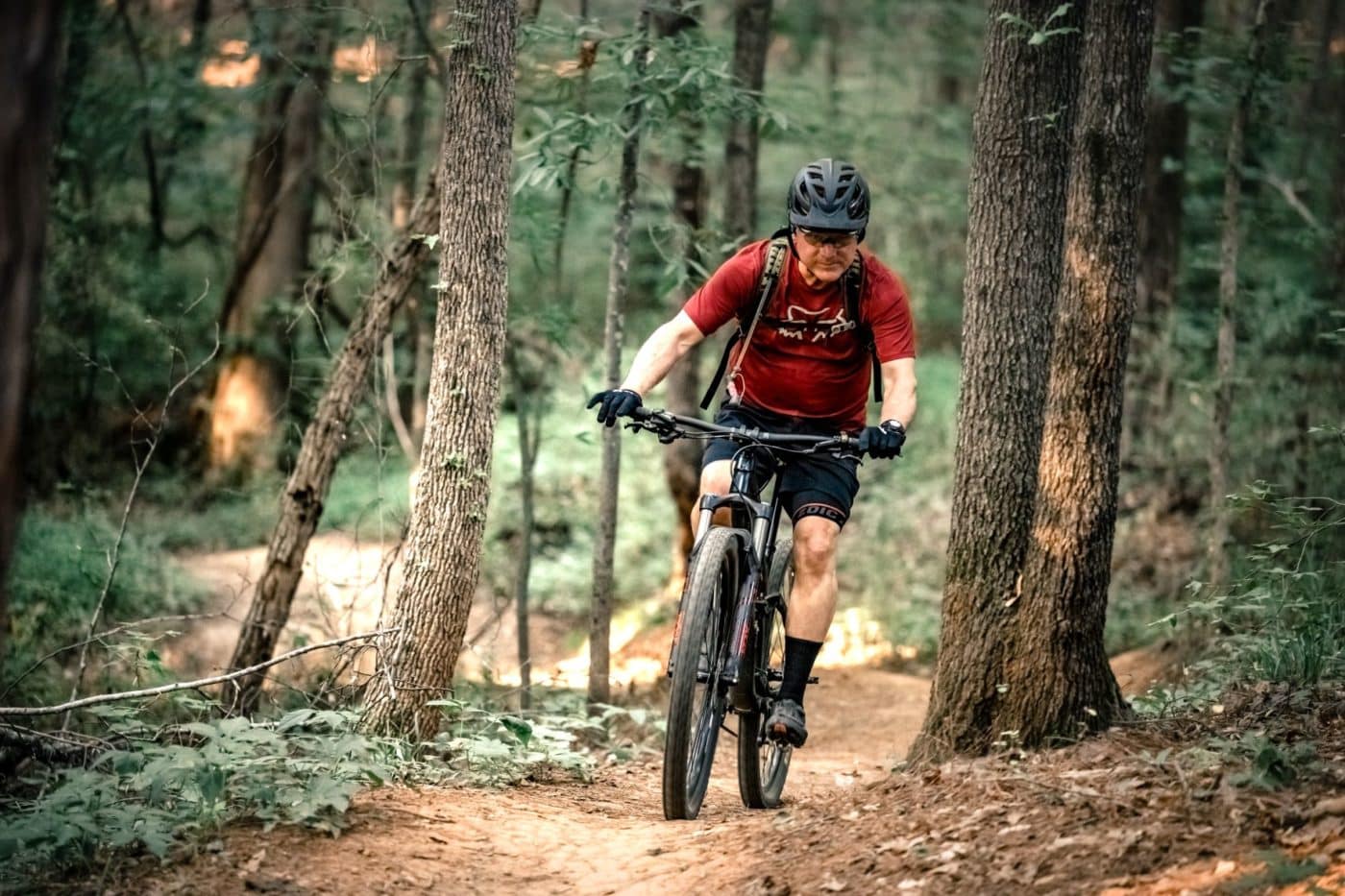 Photo of man riding a mountain bike down a trail at the Anne Springs Close Greenway