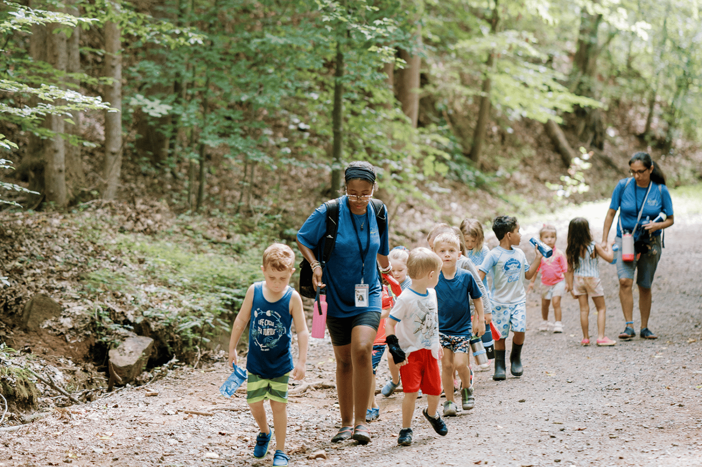 alt=Photo of Summer Camp Counselors and Campers hiking at the Anne Springs Close Greenway