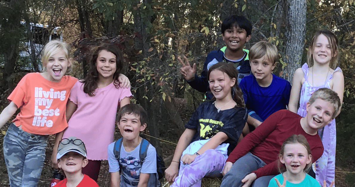 alt=Photo of children smiling at Anne Springs Close Greenway's Summer Camp