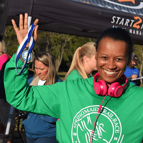Medalist at the finish line of the Springmaid Splash 5K Trail Race
