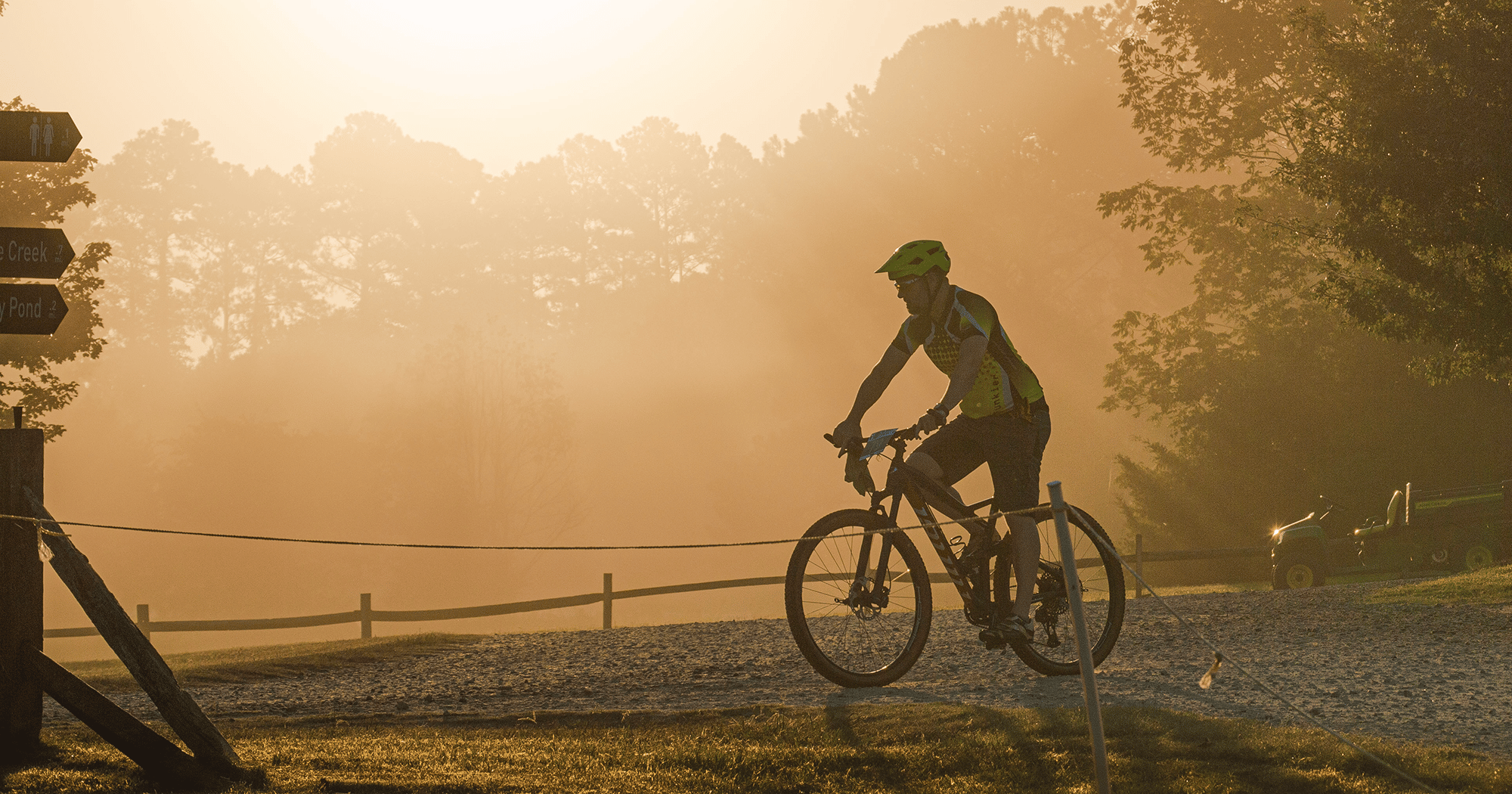 alt=Cycler biking through a trail at the Treeshaker Mountain Bike Challenge Race