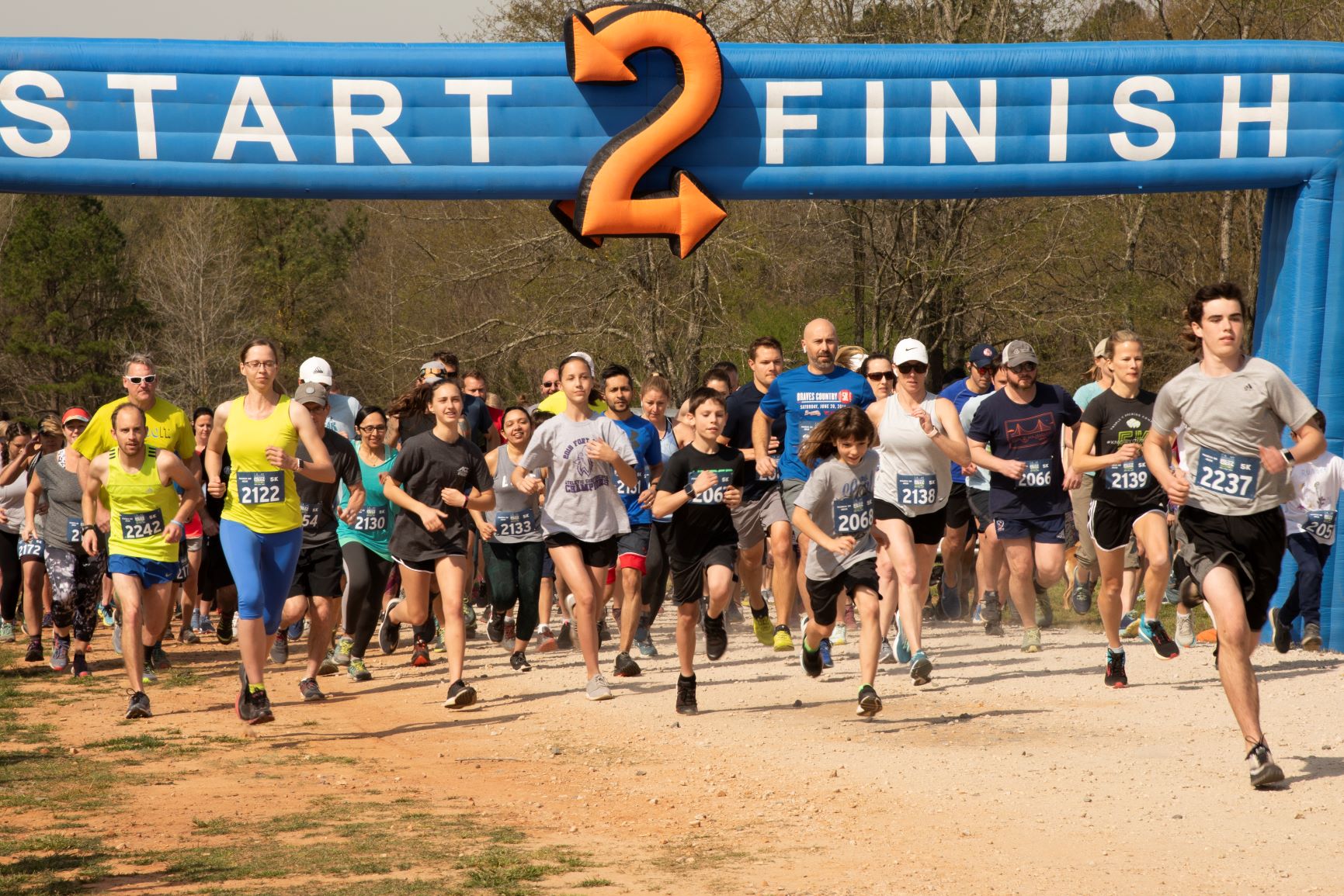 Contestants crossing the finish line of the 5K at the Anne Springs Close Greenway's annual Blue Star Blitz: A Celebration of Outdoor Recreation
