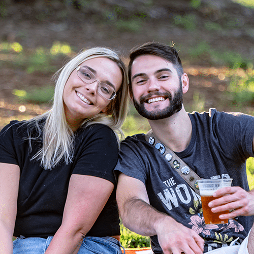 A young couple enjoying the Summer Concert Series at the Anne Springs Close Greenway