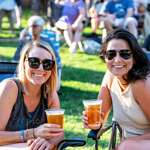 Summer Concert Series friends drink beer and enjoy music at the Anne Springs Close Greenway