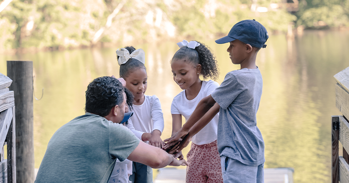 Fathers Day Facebook alt=Father and children at the Anne Springs Close Greenway's Lake Haigler
