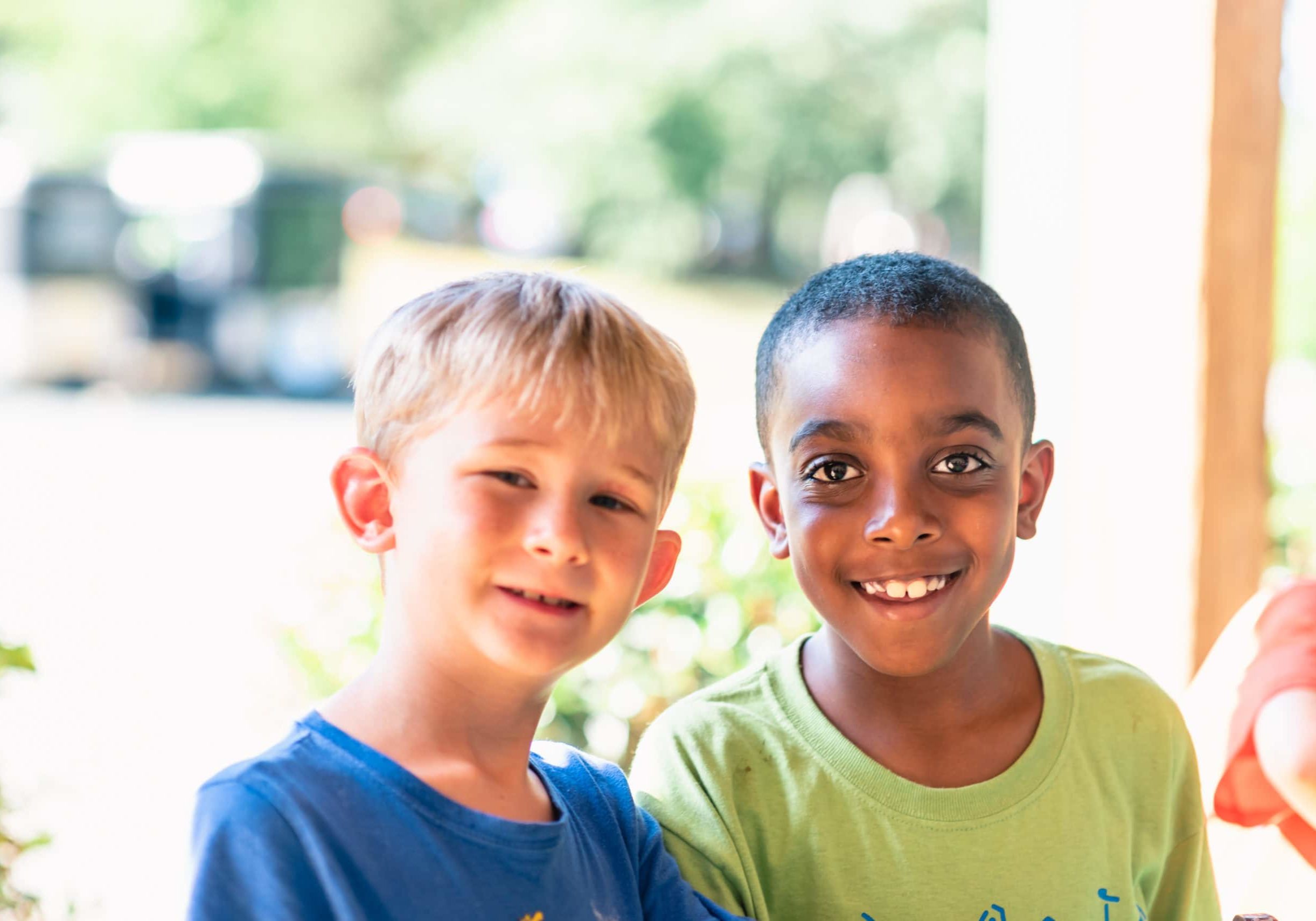 alt=Photo of 2 young boys smiling at the camera at the Anne Springs Close Greenway