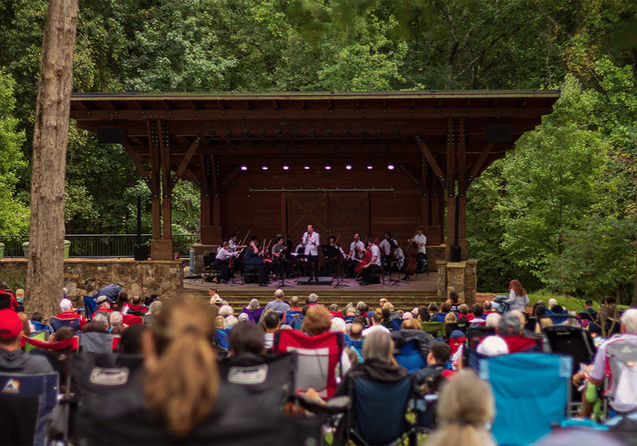 alt=Photo of Charlotte Symphony playing on-stage at the Anne Springs Close Greenway in Fort Mill for free outdoor concert