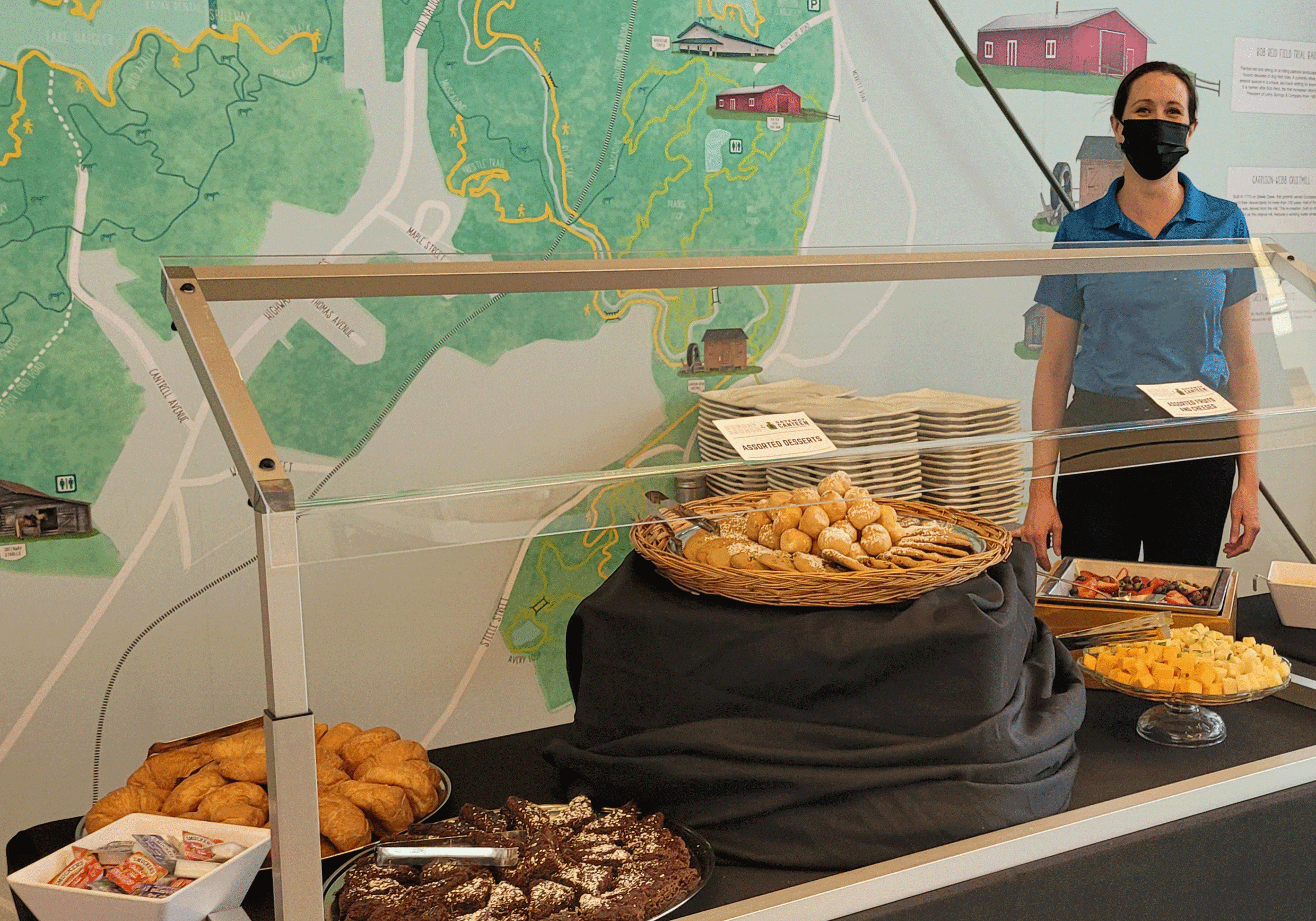 Photo of server posing next to food at the Gateway Canteen Brunch