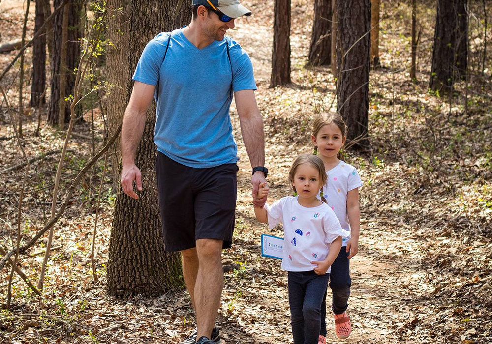 Dad and two girls hiking