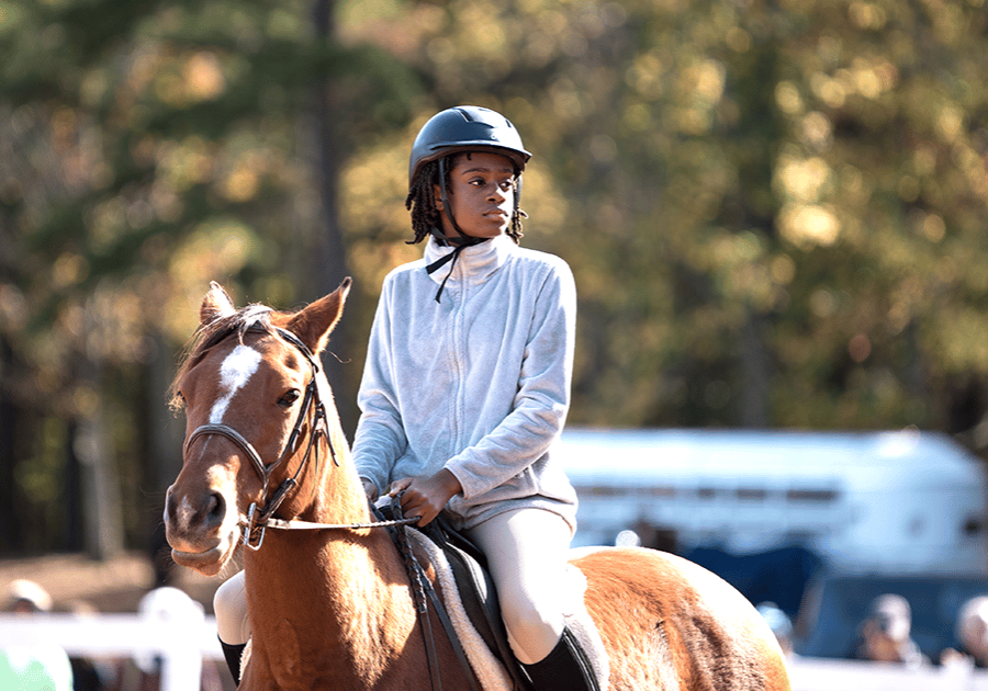 alt=Photo of young child participating in the Horse Show at Anne Springs Close Greenway