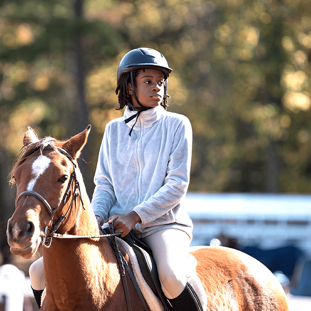 alt=Photo of young child participating in the Horse Show at Anne Springs Close Greenway