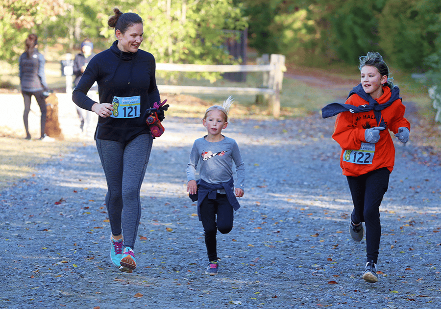 Mother and her 2 daughters running at the Anne Springs Close Greenway's Springmaid Trail Race