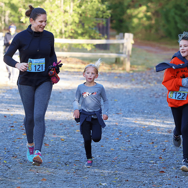 Mother and her 2 daughters running at the Anne Springs Close Greenway's Springmaid Trail Race